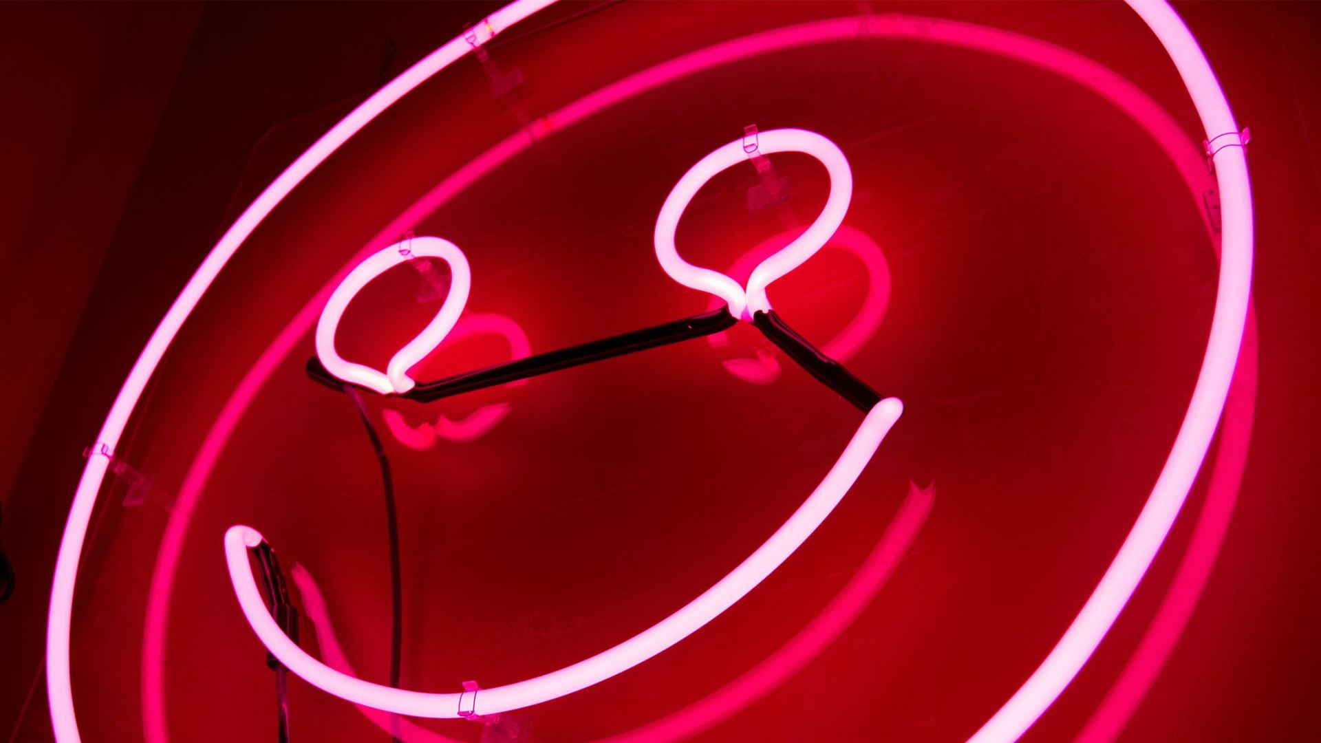 a red neon smiley