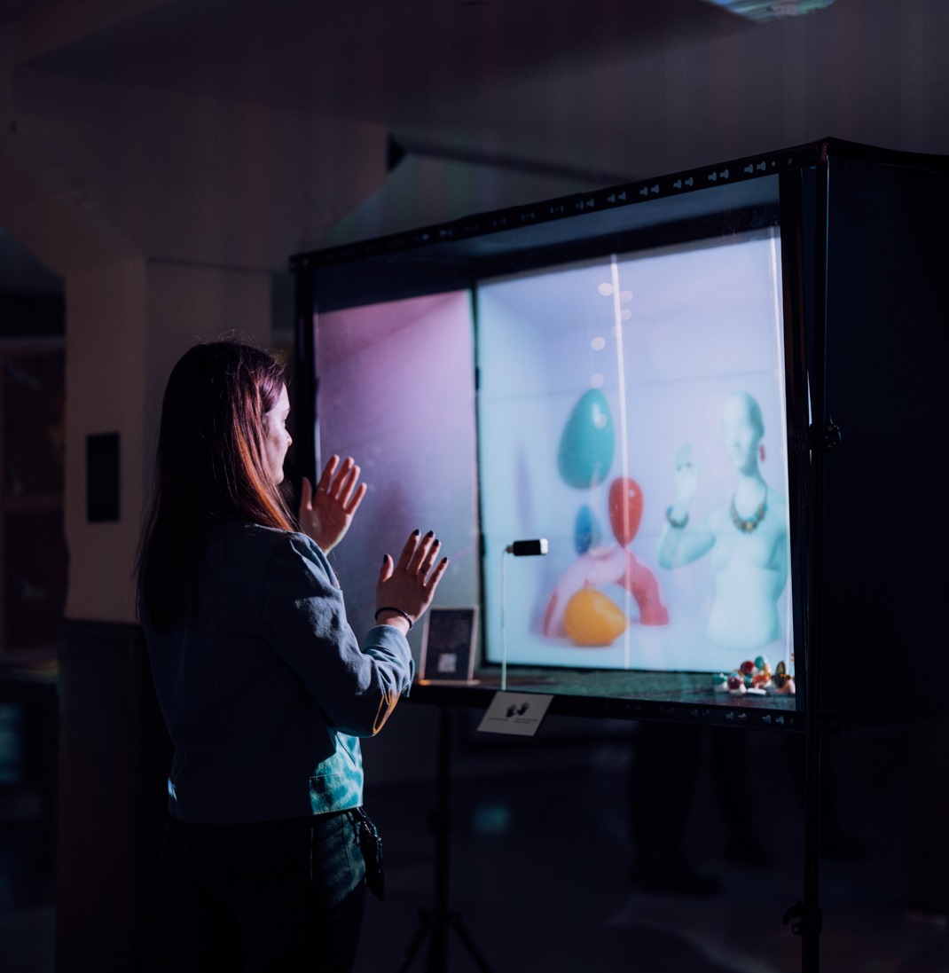Woman interacting with digital art installation
