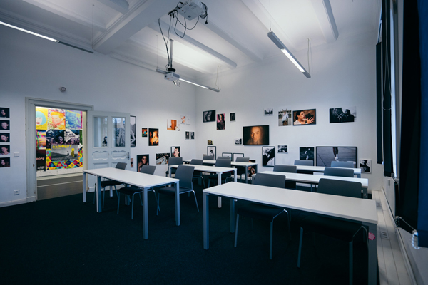 a class room with a lot of images on the wall