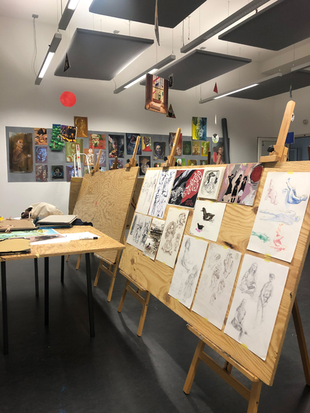creative studio with a lot of drawing pinned on boards
