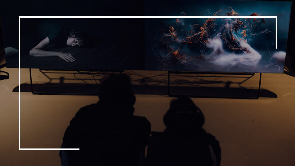 two people in front of a screen