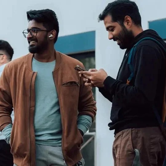 Two students smiling and talking