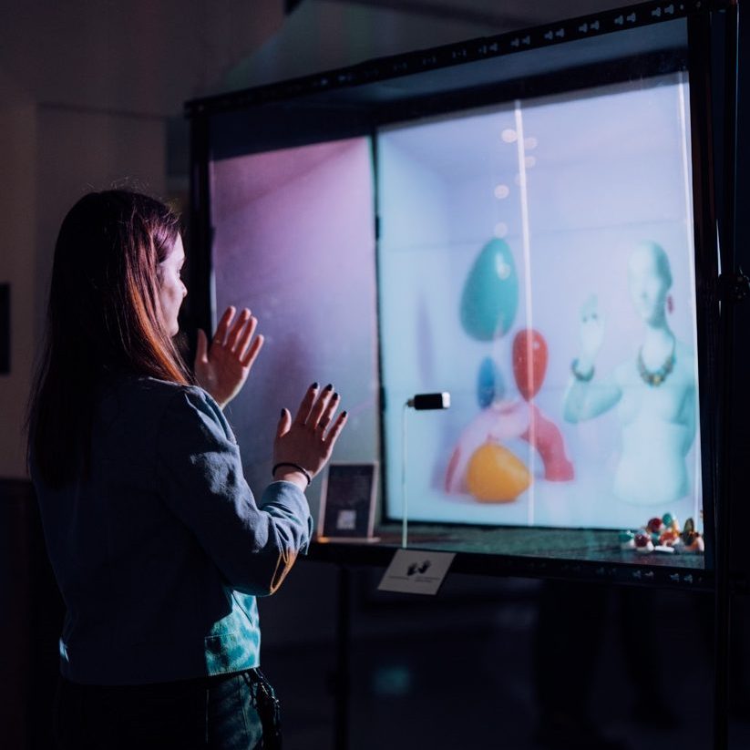 Woman interacting with digital art installation