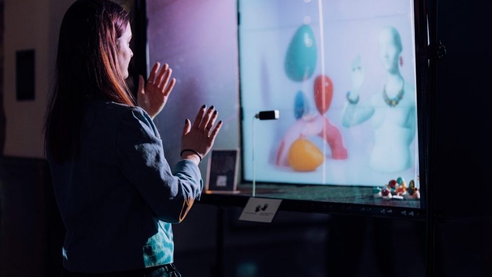 Woman interacting with digital art installation