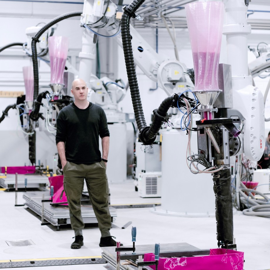 a man standing next to a robot