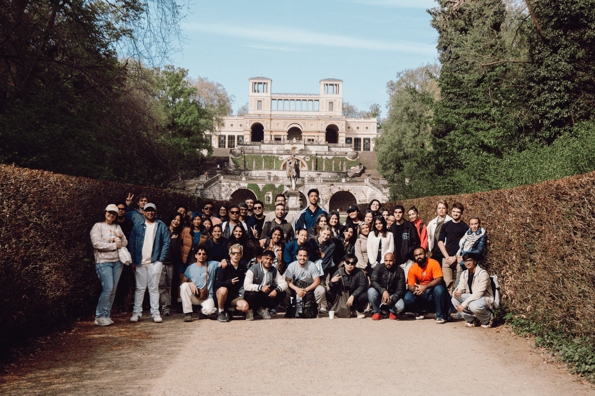 a group of people posing for a photo in front of a building
