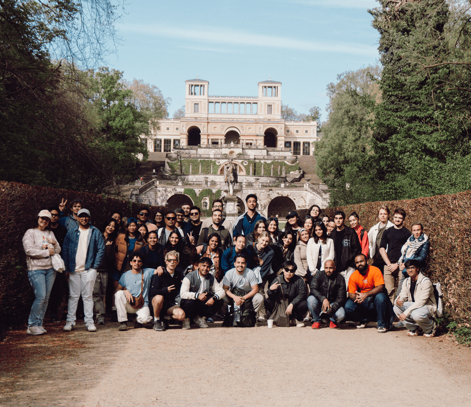 a group of people posing for a photo in front of a building