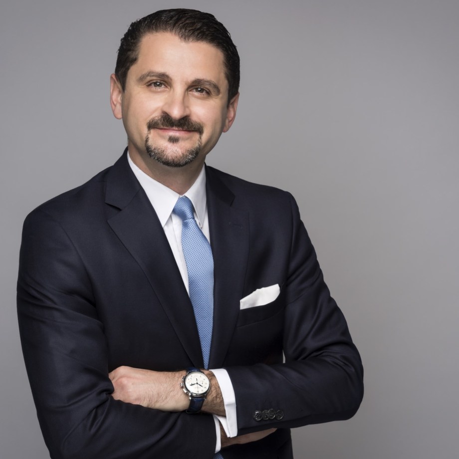 a man in a suit with his arms crossed