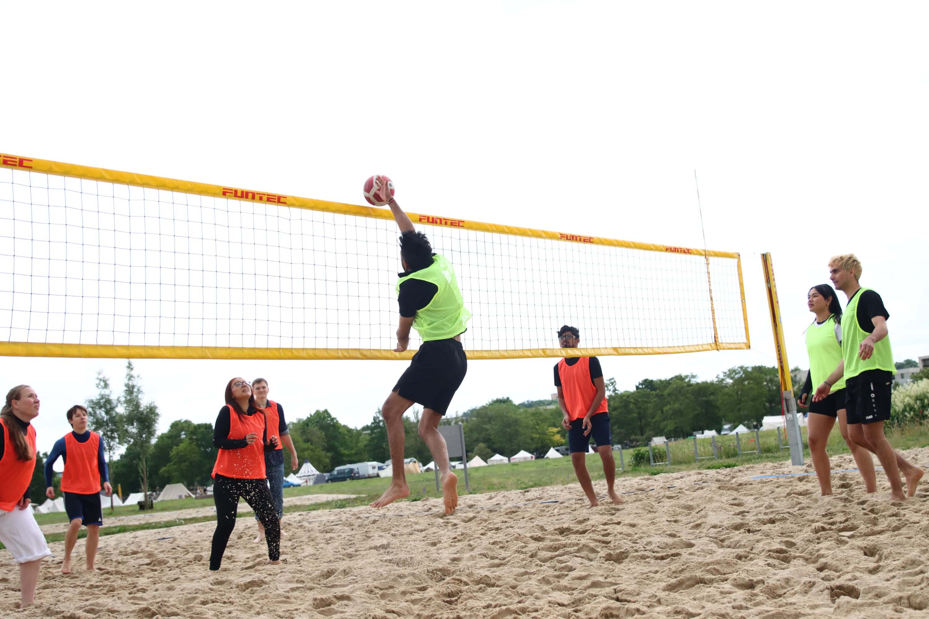 a group of people playing volleyball