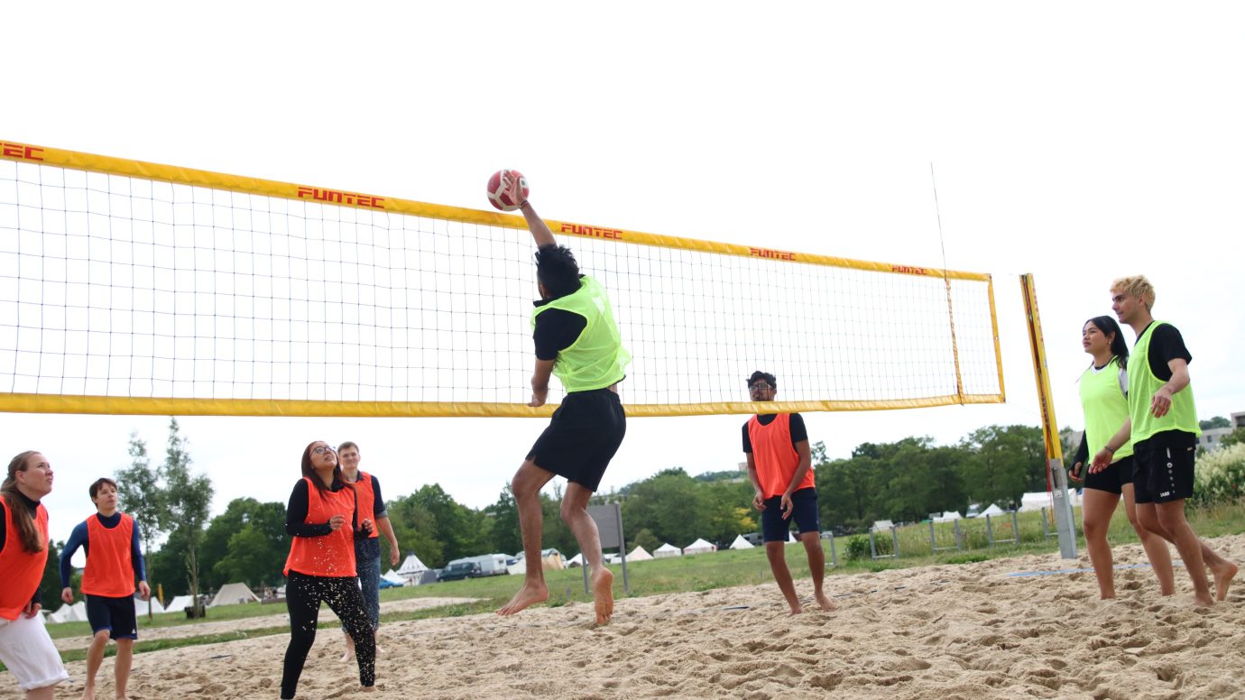 a group of people playing volleyball