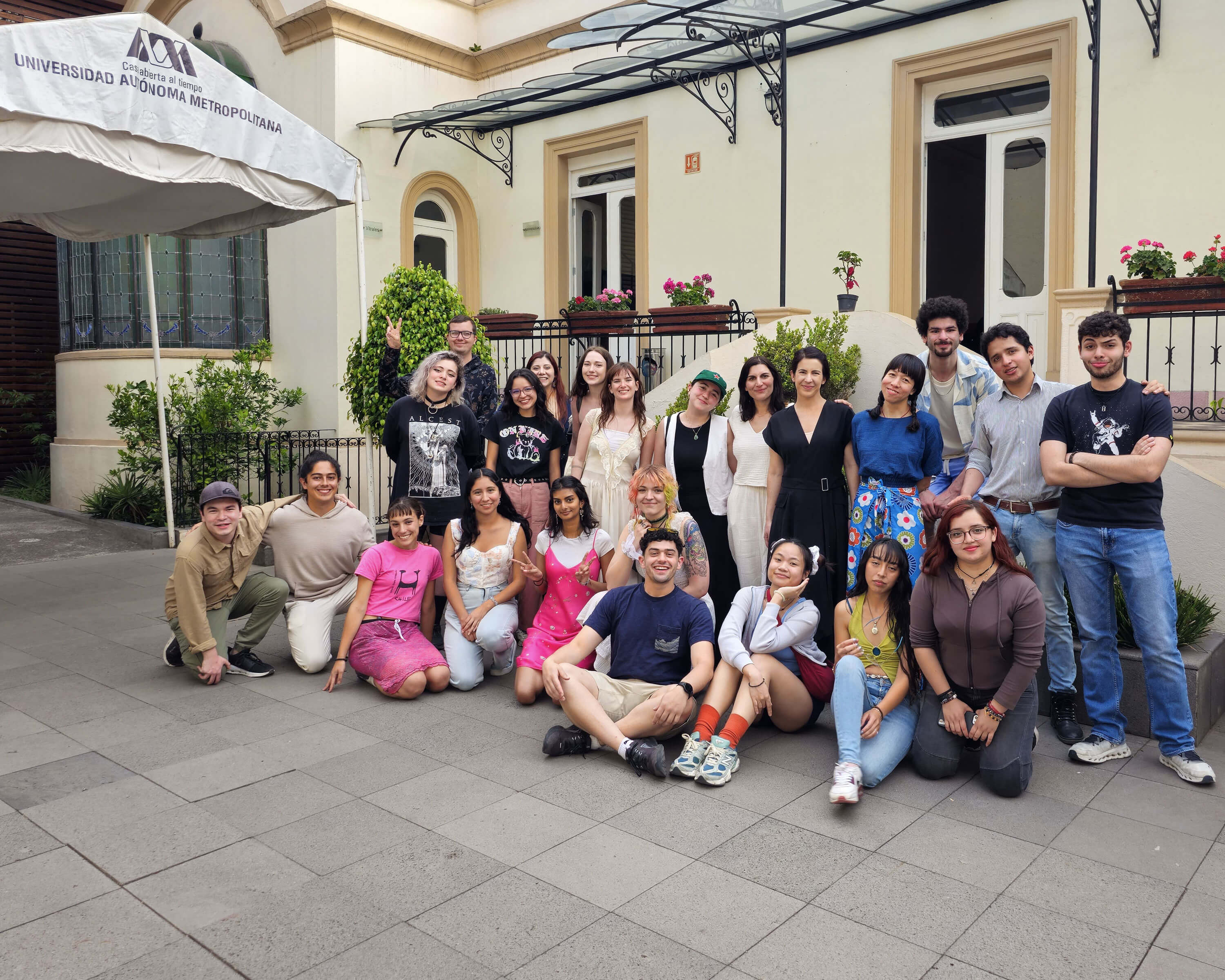 a group of people posing for a photo outside a building
