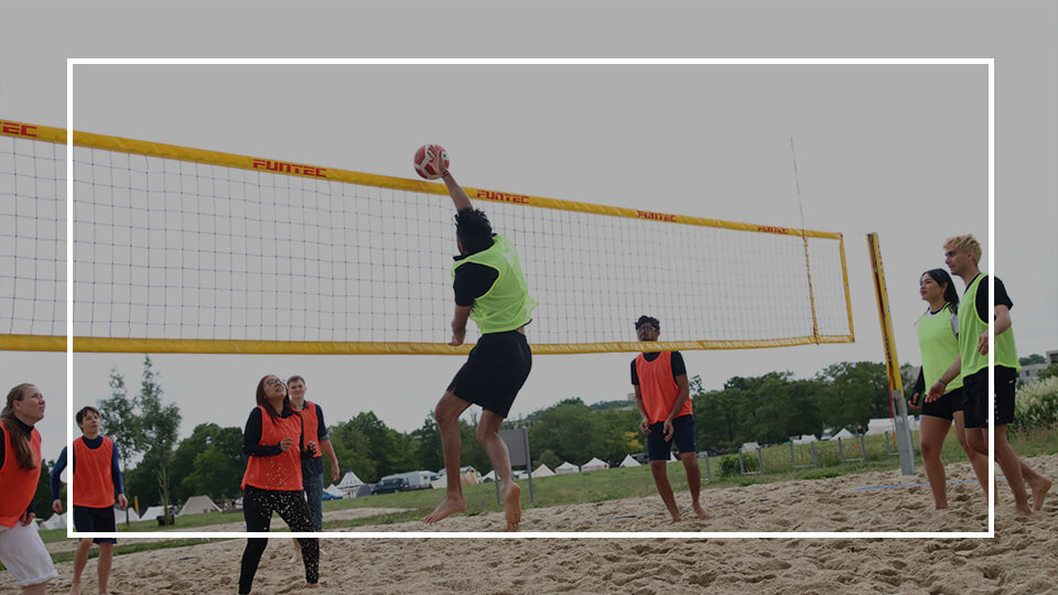 a group of people playing volleyball