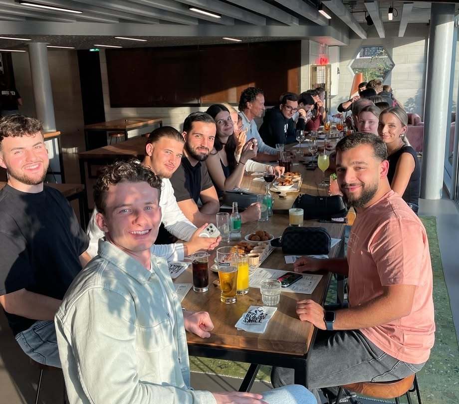 a group of people sitting at a table with drinks