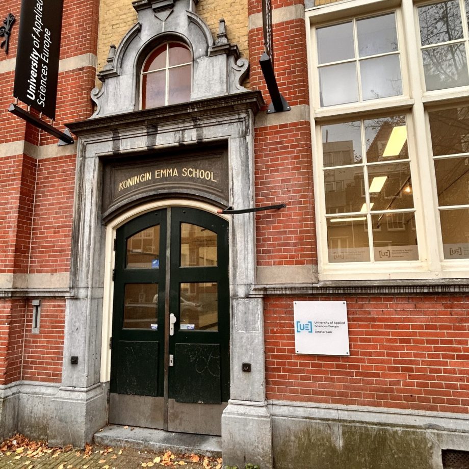 a brick building with a green door