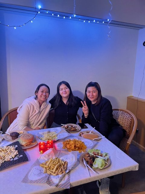 a group of people sitting at a table with food on it