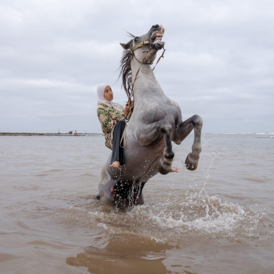 a man riding a horse in the water
