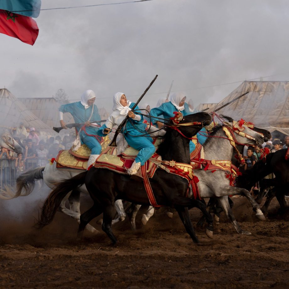 a group of men riding horses