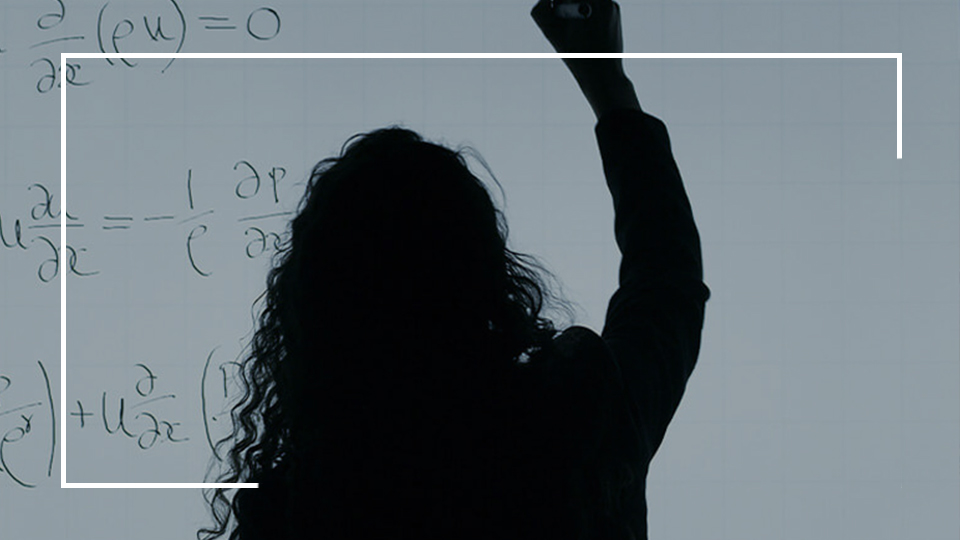 a woman writing on a whiteboard