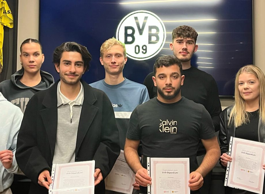 a group of people holding certificates