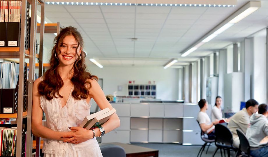 a woman standing in a library